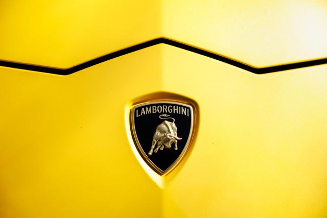 FILED - 28 March 2022, Bavaria, Munich: FILE PHOTO - The logo of the car manufacturer Lamborghini can be seen on the hood of a yellow Lamborghini Urus. Photo: Matthias Balk/dpa