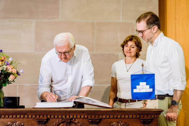 02 July 2026, Baden-Württemberg, Loerrach: German President Frank-Walter Steinmeier signs the Golden Book of the Canton of Basel-Stadt in the presence of Christine Kaufmann (EVP), mayor of Riehen. For three days, Steinmeier will carry out his official duties from the town in the "Three-Country Corner," very close to Switzerland and France. As part of his "Ortszeit Deutschland" (Local Time Germany) series of visits, Steinmeier reportedly leaves his official residence in Berlin to visit regions outside the major cities and engage in conversation with citizens there. Photo: Philipp von Ditfurth/dpa