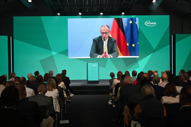 02 July 2026, Saxony, Dresden: German Chancellor Friedrich Merz is seen on a screen at the opening of Semiconductor Plant of the Infineon Smart Power Fab. Photo: Robert Michael/dpa