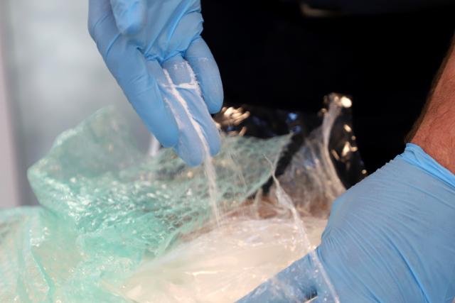 FILED - 03 March 2026, North Rhine-Westphalia, Cologne: FILE PHOTO - Jens Ahland, press spokesman for the main customs office in Cologne, lets ketamine trickle from a glove. Photo: -/dpa
