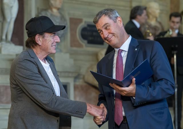 03 July 2026, Bavaria, Munich: Musician Stefan Zauner (L), is presented with the Bavarian Order of Merit by Markus Soeder, Minister-President of Bavaria. The Bavarian Order of Merit is awarded "as a token of honor and gratitude for outstanding service to the Free State of Bavaria and the Bavarian people." Photo: Peter Kneffel/dpa