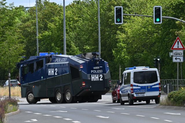 03 July 2026, Thuringia, Erfurt: Police water cannons are stationed near the Erfurt Exhibition Center. The Alternative for Germany's (AfD) national party convention will take place at the Erfurt Exhibition Center on July 4 and 5. Photo: Martin Schutt/dpa