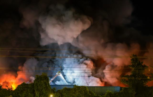 03 July 2026, Baden-Württemberg, Stuttgart: Firefighters battle a fire at an industrial park in Stuttgart. Photo: Christoph Schmidt/dpa