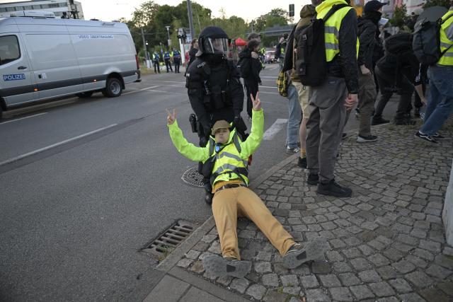 04 July 2026, Thuringia, Erfurt: A police officer drags a protester during a demonstration against the national party convention of the Alternative for Germany (AfD) pary. The AfD's national party convention is taking place on July 4 and 5 at the Erfurt Convention Center. Photo: Jacob Schröter/dpa