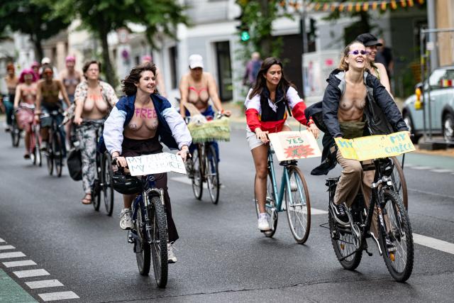 04 July 2026, Berlin: People with their tops off participate in a bicycle demonstration with the slogan "We are coming out-free the nipple-gender equality" for Equality and Self-Determination. Photo: Fabian Sommer/dpa