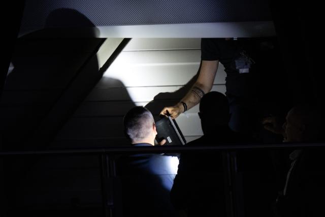04 July 2026, Thuringia, Erfurt: Technicians remove a Bluetooth speaker hidden behind a curtain under the hall's roof; it had previously been identified as a possible source of acoustic interference, during the Alternative for Germany (AfD) federal party convention. Photo: Sebastian Kahnert/dpa
