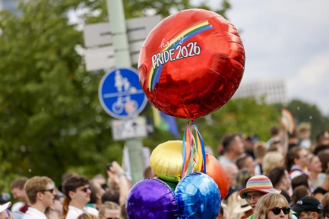 05 July 2026, North Rhine-Westphalia, Cologne: A participant holds a balloon reading "Happy Pride 2026" during the Christopher Street Day parade. Photo: Thomas Banneyer/dpa