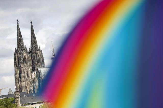 05 July 2026, North Rhine-Westphalia, Cologne: A participant carries a rainbow-coloured umbrella during the Christopher Street Day parade. Photo: Thomas Banneyer/dpa