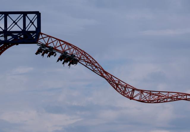 05 July 2026, Bavaria, Tuerkheim: Visitors to Allgaeu Skyline Park sit in a roller coaster on the "Allgäu Flieger" flying carousel. Photo: Karl-Josef Hildenbrand/dpa