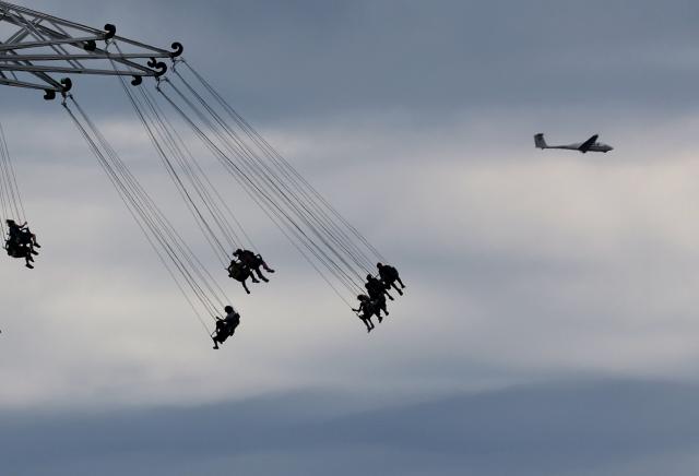 05 July 2026, Bavaria, Tuerkheim: Visitors to Allgaeu Skyline Park sit in front of a glider on the "Allgäu Flieger" flying carousel. Photo: Karl-Josef Hildenbrand/dpa