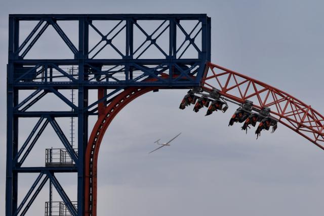 05 July 2026, Bavaria, Tuerkheim: Visitors to Allgaeu Skyline Park sit in a roller coaster on the "Allgäu Flieger" flying carousel. Photo: Karl-Josef Hildenbrand/dpa