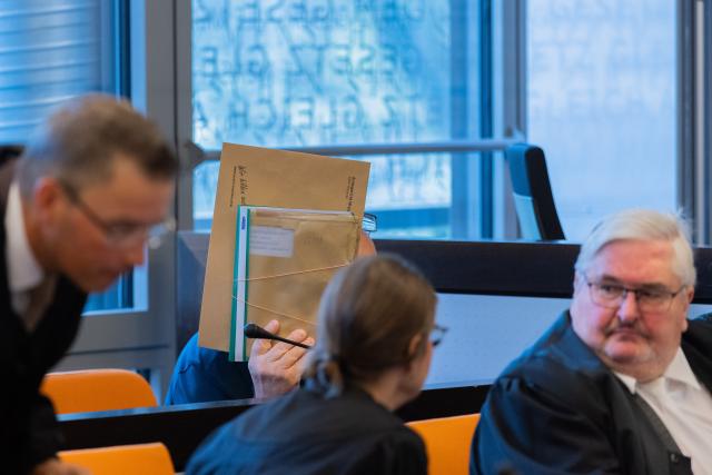 06 July 2026, North Rhine-Westphalia, Wuppertal: The main defendant (Back) sits behind his attorneys in a courtroom at the Justice Center. The trial regarding a large weapons cache in Remscheid has begun. Photo: Rolf Vennenbernd/dpa