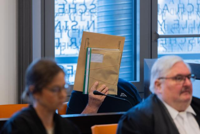 06 July 2026, North Rhine-Westphalia, Wuppertal: The main defendant (C) sits behind his attorneys in a courtroom at the Justice Center. The trial regarding a large weapons cache in Remscheid has begun. Photo: Rolf Vennenbernd/dpa