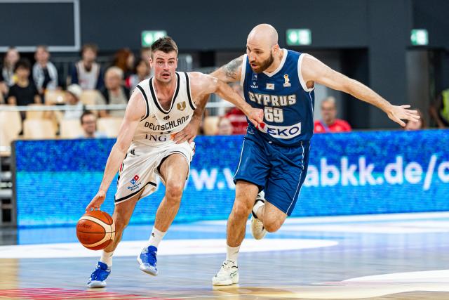 06 July 2026, Bavaria, Bamberg: Germany's Jonas Mattisseck (L) and Cyprus' Roberto Mantovani battle for the ball during the Basketball World Cup Qualifiers Group E Basketball match between Germany and Cyprus. Photo: Daniel Löb/dpa