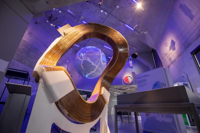 FILED - 14 September 2021, Bavaria, Nuremberg: FILE PHOTO - A Wendelstein 7-AS stellarator coil from 1990, part of an experimental nuclear fusion reactor, stands in front of a globe that serves as a projection surface for maps showing environmental factors, in the exhibition halls of the Zukunftsmuseum Nuremberg, a branch of the Deutsches Museum in Munich. German start-up Proxima Fusion has raised ·411 million ($470 million) in a funding round backed by investors including Google and utility RWE, as it seeks to build a commercial fusion power plant by the end of the 2030s. Photo: Daniel Karmann/dpa