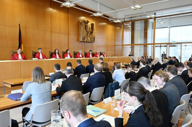 07 July 2026, Baden-Wuerttemberg, Karlsruhe: The First Senate of the Federal Constitutional Court (L-R) Guenter Spinner, Martin Eifert, Ines Haertel, Yvonne Ott, Chair of the Senate and President of the Court Stephan Harbarth, Henning Radtke, Heinrich Amadeus Wolff, and Miriam Messling opens the oral hearing on the Bavarian Police Duties Act. Photo: Uli Deck/dpa