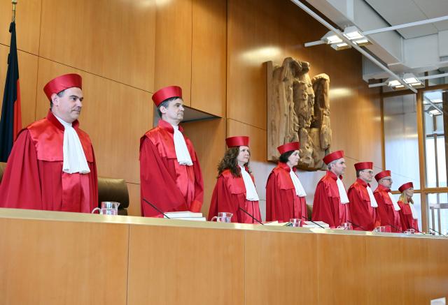 07 July 2026, Baden-Wuerttemberg, Karlsruhe: The First Senate of the Federal Constitutional Court (L-R) Guenter Spinner, Martin Eifert, Ines Haertel, Yvonne Ott, Chair of the Senate and President of the Court Stephan Harbarth, Henning Radtke, Heinrich Amadeus Wolff, and Miriam Messling opens the oral hearing on the Bavarian Police Duties Act. Photo: Uli Deck/dpa