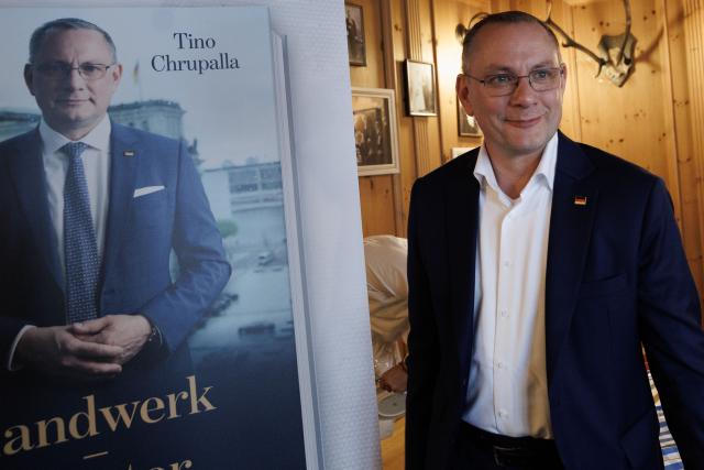 07 July 2026, Berlin: Federal chairman and parliamentary group leader of the Alternative for Germany (AfD) Tino Chrupalla stands next to the poster for his book during the launch of his book "Handwerk - Meister - Politik" at the "Augustiner" restaurant on Gendarmenmarkt. Photo: Carsten Koall/dpa