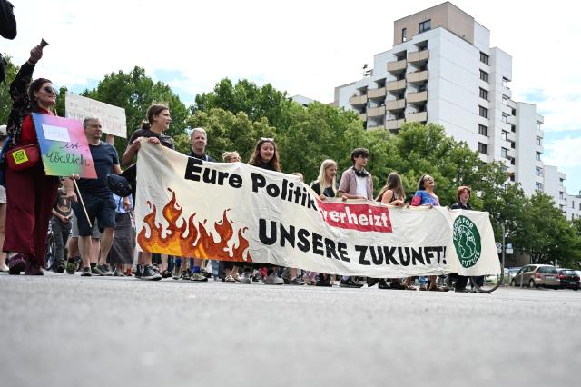 10 July 2026, Berlin: Protesters holding a sign that reads "Your policies are squandering our future!" take part in a Fridays for Future protest. Fridays for Future has called for nationwide demonstrations demanding the resignation of Federal Minister of Economic Affairs Reiche. Photo: Markus Lenhardt/dpa