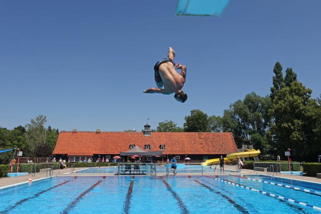 10 July 2026, Saxony-Anhalt, Wernigerode: A young man dives into the cool water at the Waldhofbad in Wernigerode as a participant in the cannonball championship. Photo: Matthias Bein/dpa