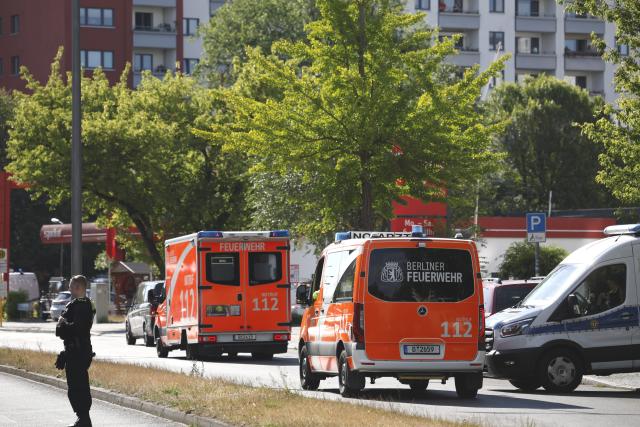11 July 2026, Berlin: Ambulances and medical personnel remain on standby outside a supermarket. Police brought an end to the overnight crisis after a man held a woman hostage inside the store since late Friday evening. Photo: Carsten Koall/dpa