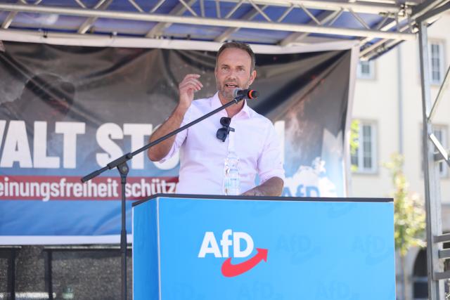 11 July 2026, Mecklenburg-Western Pomerania, Rostock: Enrico Schult, the Alternative for Germany (AfD) top candidate for the 2026 state election in Mecklenburg-Western Pomerania, speaks at an AfD rally on the Neuer Markt under the slogan "Stop Left-Wing Violence!". Photo: Danny Gohlke/dpa