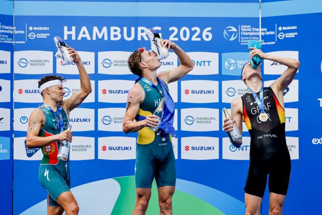 11 July 2026, Hamburg: (L-R) Portugal's Second-placed Vasco Vilaca, Australia's winner Matthew Hauser, and Germany's third-placed Henry Graf celebrate on the podium after the men's sprint race at the ITU World Triathlon Series/World Championship, comprising a 750-metre swim, a 20-kilometre bike ride and a five-kilometre run. Photo: Philipp Szyza/dpa