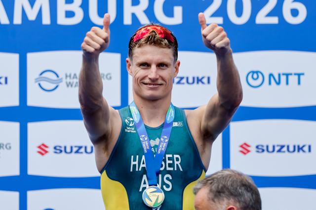 11 July 2026, Hamburg: Australia's winner Matthew Hauser celebrates on the podium after the men's sprint race at the ITU World Triathlon Series/World Championship, comprising a 750-metre swim, a 20-kilometre bike ride and a five-kilometre run. Photo: Philipp Szyza/dpa