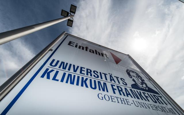 FILED - 04 August 2016, Hesse, Frankfurt/Main: FILE PHOTO - A sign points to the entrance to the University Hospital. Photo: Boris Roessler/dpa