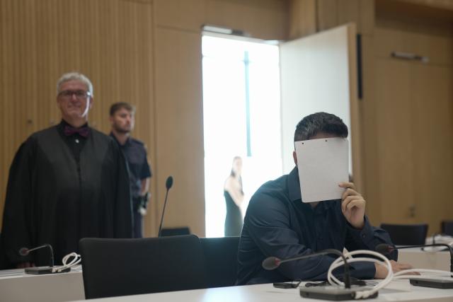 13 July 2026, Bavaria, Munich: A defendant (R) sits in the courtroom during the trial of an Iraqi couple convicted of enslaving two Yazidi girls and of membership in the terrorist organization Islamic State (IS) at the Higher Regional Court in Munich. Photo: Ehsan Monajati/dpa