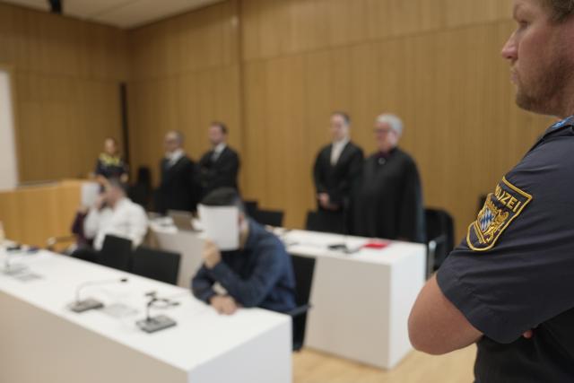 13 July 2026, Bavaria, Munich: (L-C) The defendants are seated in the courtroom during the trial of an Iraqi couple convicted of enslaving two Yazidi girls and of membership in the terrorist organization Islamic State (IS) at the Higher Regional Court in Munich. Photo: Ehsan Monajati/dpa