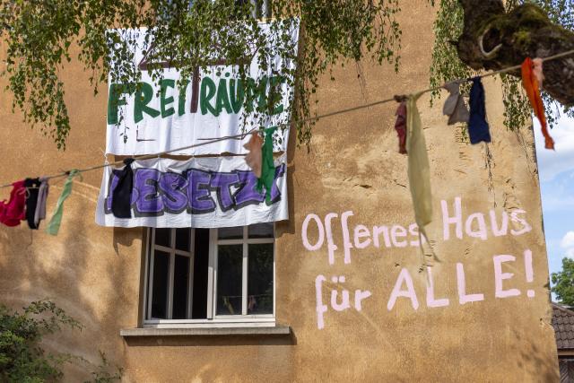 13 July 2026, Hesse, Giessen: The words "Open House for Everyone!" are written on the Justus Liebig University building on Hein-Heckroth-Strasse, which has been occupied by activists. Photo: Christian Lademann/dpa
