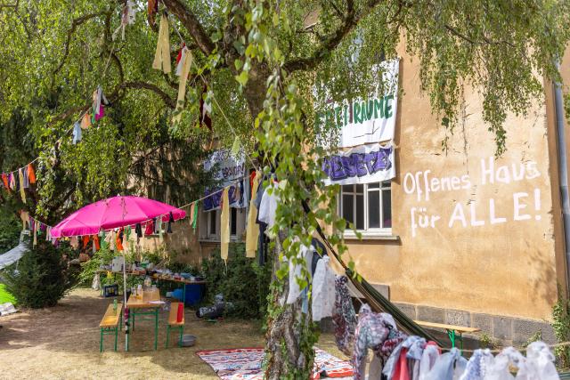 13 July 2026, Hesse, Giessen: Posters and banners hang on the Justus Liebig University building on Hein-Heckroth-Strasse, which has been occupied by activists. The words "Open House for Everyone!" are written on the building. Photo: Christian Lademann/dpa