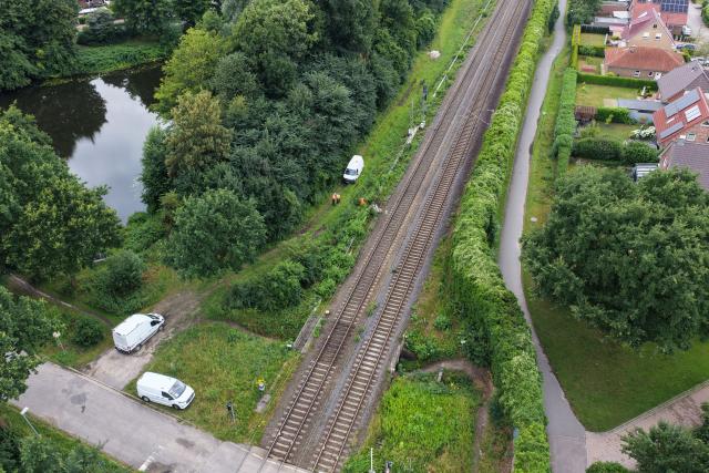 14 July 2026, Lower Saxony, Neu Wulmstorf: An aerial view shows a repair crew working on a railway distribution box following a suspected arson attack in Neu Wulmstorf. Train services between Hamburg and Cuxhaven were suspended after a fire damaged the installation overnight. Photo: Sebastian Peters/NEWS5/dpa