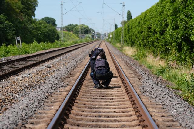 14 July 2026, Lower Saxony, Neu Wulmstorf: Police are collecting evidence following a suspected arson attack on the railroad line between Hamburg and Cuxhaven. Train service has been suspended following a fire on the railroad line between Hamburg and Cuxhaven. Police reported that a distribution box caught fire overnight in Neu Wulmstorf, Lower Saxony. Photo: Marcus Brandt/dpa