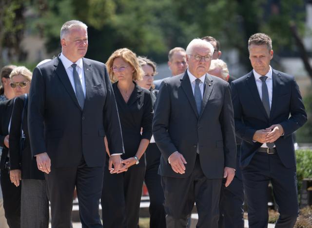 14 July 2026, Rhineland-Palatinate, Ahrweiler: Gordon Schnieder (L), Minister-President of Rhineland-Palatinate, his deputy Sabine Baetzing-Lichtenthaeler, German President Frank-Walter Steinmeier, and Pascal Rowald, mayor of Bad Neuenahr-Ahrweiler, walk across the cemetery in Ahrweiler to lay a wreath. Photo: Boris Roessler/dpa-Pool/dpa