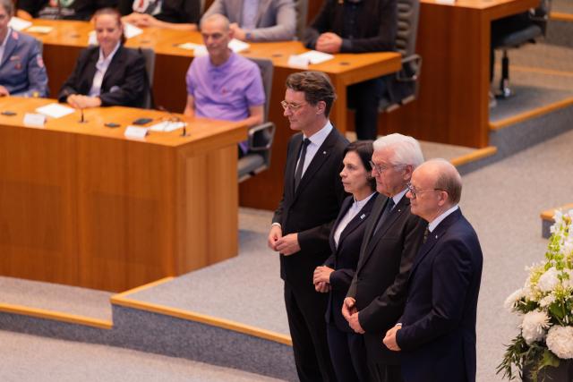 14 July 2026, North Rhine-Westphalia, Duesseldorf: North Rhine-Westphalia Minister-President Hendrik Wuest (L), Pastor Claudia Mueller-Bueck, German President Frank-Walter Steinmeier (2-R), and State Parliament President Andre Kuper (R) attend a state memorial marking the fifth anniversary of the 2021 flood disaster at the State Parliament in Duesseldorf. Photo: Rolf Vennenbernd/dpa