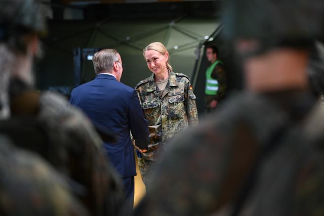 14 July 2026, Lower Saxony, Leer: Boris Pistorius, German Minister of Defense, surprises Rear Admiral Mascha-Christine Gross with a promotion during his visit to the "Ostfriesland" Rapid Medical Response Force Command. Pistorius learns about the unit's specialized capabilities for providing medical support during missions both at home and abroad. Photo: Lars Penning/dpa
