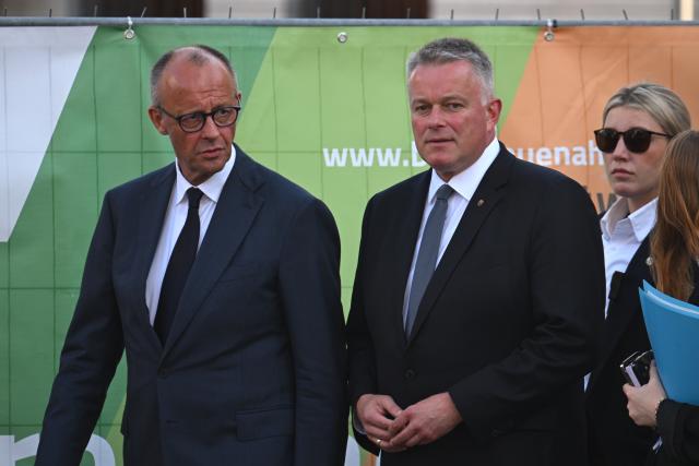 14 July 2026, Rhineland-Palatinate, Bad Neuenahr-Ahrweiler: German Chancellor Friedrich Merz (L) and Gordon Schnieder, Minister-President of Rhineland-Palatinate, tour the municipal construction site in the Kurpark, on the anniversary of the 2021 European floods. During the flood disaster in the summer of 2021, 136 people died in Rhineland-Palatinate, 135 of them in the Ahr Valley. Photo: Boris Roessler/dpa