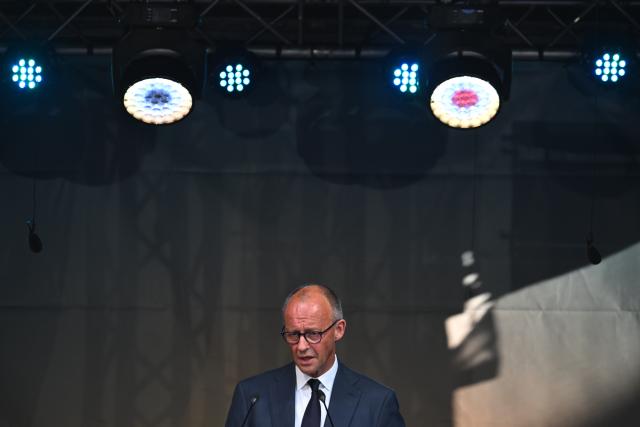 14 July 2026, Rhineland-Palatinate, Bad Neuenahr-Ahrweiler: German Chancellor Friedrich Merz, speaks at the central memorial ceremony marking the fifth anniversary the 2021 European floods, in the Ahr Valley on the market square. During the flood disaster in the summer of 2021, 136 people died in Rhineland-Palatinate, 135 of them in the Ahr Valley. Photo: Boris Roessler/dpa