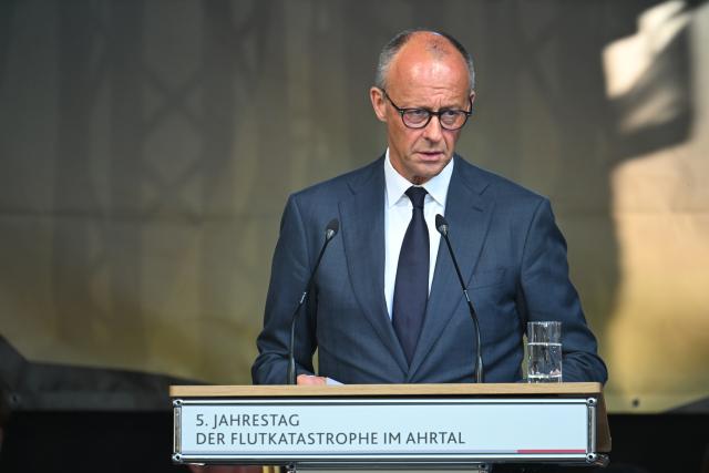 14 July 2026, Rhineland-Palatinate, Bad Neuenahr-Ahrweiler: German Chancellor Friedrich Merz, speaks at the central memorial ceremony marking the fifth anniversary the 2021 European floods, in the Ahr Valley on the market square. During the flood disaster in the summer of 2021, 136 people died in Rhineland-Palatinate, 135 of them in the Ahr Valley. Photo: Boris Roessler/dpa