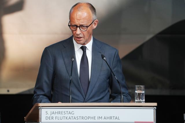 14 July 2026, Rhineland-Palatinate, Bad Neuenahr-Ahrweiler: German Chancellor Friedrich Merz, speaks at the central memorial ceremony marking the fifth anniversary the 2021 European floods, in the Ahr Valley on the market square. During the flood disaster in the summer of 2021, 136 people died in Rhineland-Palatinate, 135 of them in the Ahr Valley. Photo: Thomas Frey/dpa
