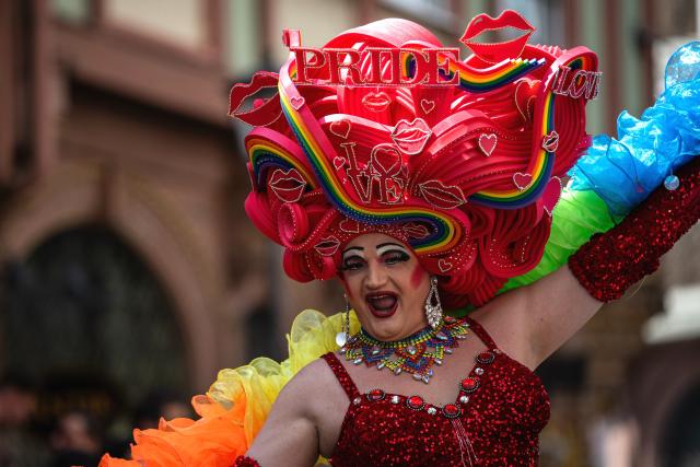 18 July 2026, Hesse, Frankfurt am Main: A drag queen wears a headpiece reading "Love" and "Pride" during Christopher Street Day (CSD) in Frankfurt am Main, Germany. This year's CSD is held under the motto "Democracy needs no alternative!" Photo: Hannes P. Albert/dpa