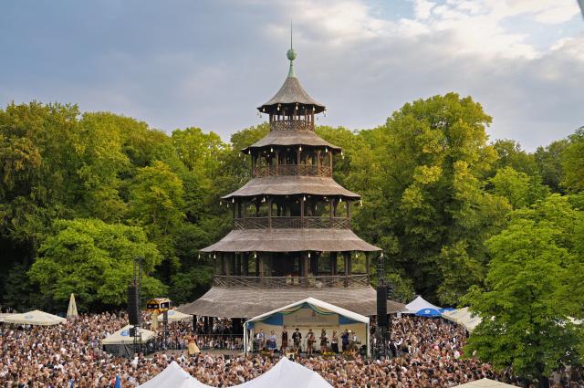 19 July 2026, Bavaria, Munich: Early in the morning, visitors dance shoulder to shoulder at the Kocherlball at the Chinese Tower.  This traditional open-air folk dance festival at sunrise in the English Garden began around 1880. It has been held again since 1989, usually on the third Sunday in July. Photo: Uwe Lein/dpa