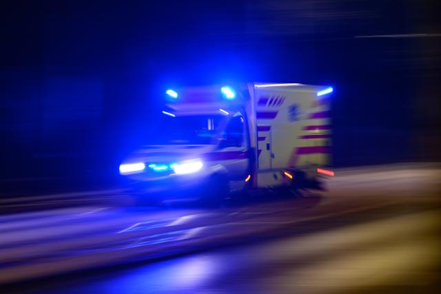 FILED - 24 January 2025, Saxony, Dresden: File Photo - An ambulance is responding to a call in the evening with its emergency lights flashing. Photo: Robert Michael/dpa