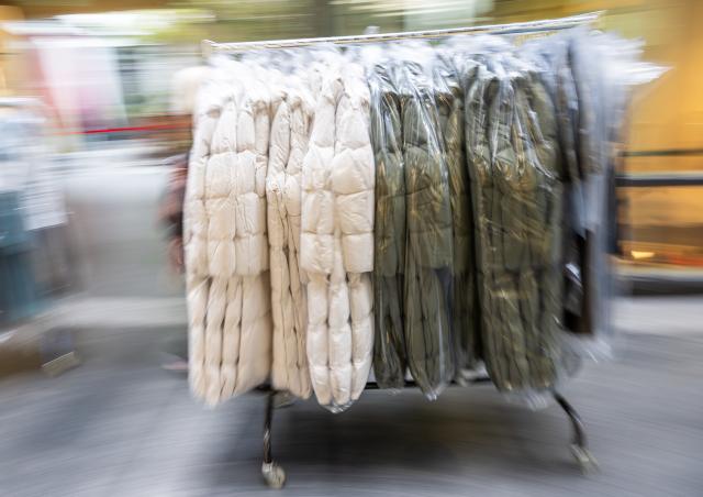 FILED - 07 October 2022, Bayern, München: File Photo - Winter coats move along a warehouse conveyor belt for transport to a retail store. Photo: Peter Kneffel/dpa