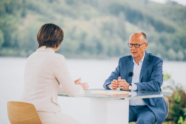 HANDOUT - 19 July 2026, North Rhine-Westphalia, Meschede: This handout provided by ZDF, shows German Chancellor Friedrich Merz speaking to Diana Zimmermann, head of the ZDF Berlin studio, during the 2026 ZDF Summer Interview in Meschede. Photo: Dominik Asbach/ZdF/dpa - ATTENTION: editorial use only in connection with the latest coverage and only if the credit mentioned above is referenced in full