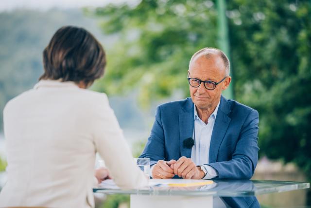 HANDOUT - 19 July 2026, North Rhine-Westphalia, Meschede: This handout provided by ZDF, shows German Chancellor Friedrich Merz speaking to Diana Zimmermann, head of the ZDF Berlin studio, during the 2026 ZDF Summer Interview in Meschede. Photo: Dominik Asbach/ZdF/dpa - ATTENTION: editorial use only in connection with the latest coverage and only if the credit mentioned above is referenced in full
