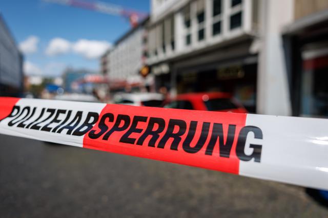 19 July 2026, Bavaria, Nuremberg: Police tape secures the crime scene outside an amusement arcade where an employee was killed. Police said a 45-year-old suspect was arrested nearby. Photo: -/dpa