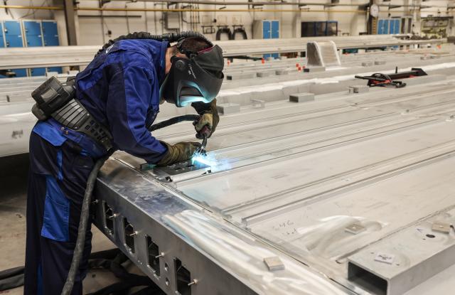 FILED - 17 July 2023, North Rhine-Westphalia, Krefeld: FILE PHOTO - A Siemens employee is welding a component for a new train. Photo: Oliver Berg/dpa